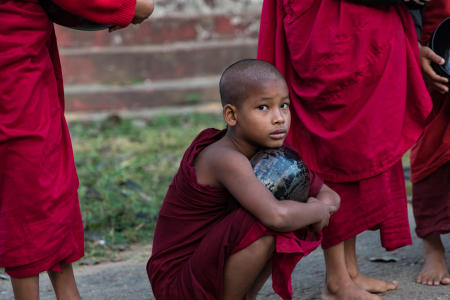 Young monk before collecting the morning rice offering from villagers