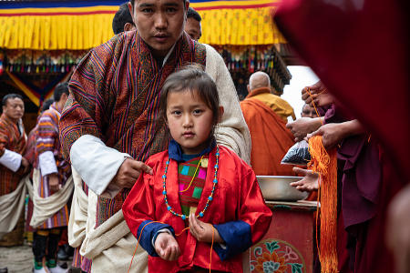 Young girl after giving an offering, Gasa Tshechu festival