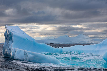 Iceberg with Greenpeace ship in the distance, Gerlache Strait